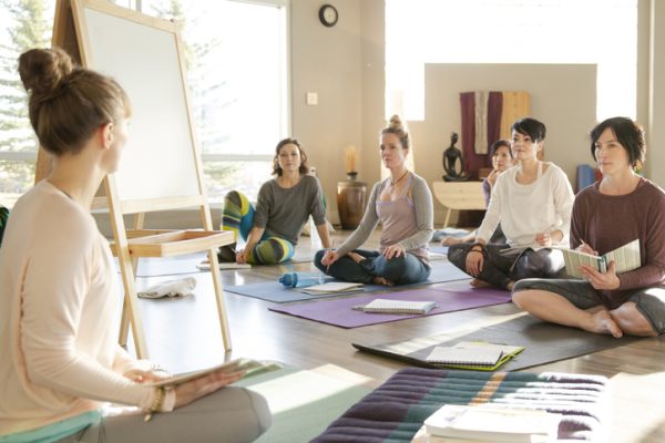 Women with journals at restorative yoga retreat
